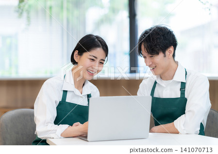 young male and female cafe staff young male and female cafe staff 141070713