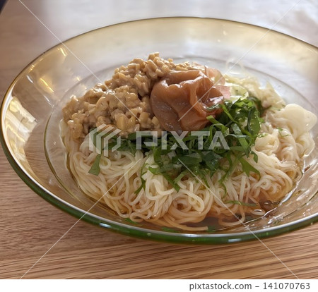 To prevent summer fatigue, chilled somen noodles with natto and pickled plums, garnished with shiso leaves and myoga ginger. To prevent summer fatigue, chilled somen noodles with natto and pickled plums, garnished with shiso leaves and myoga ginger. 141070763