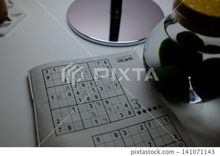 A partially solved sudoku puzzle with green numbers A partially solved sudoku puzzle with green numbers 141071143