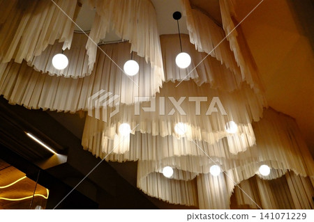 Layered, light, translucent drapes cascade from ceiling Layered, light, translucent drapes cascade from ceiling 141071229