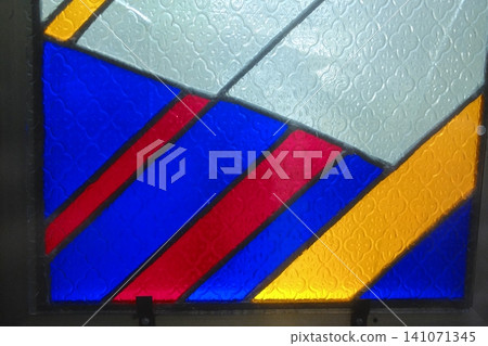 Stained glass features vibrant colors and textured clear glass panels Stained glass features vibrant colors and textured clear glass panels 141071345