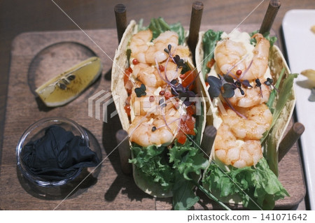 Two tempting shrimp tacos filled with succulent shrimp, fresh lettuce Two tempting shrimp tacos filled with succulent shrimp, fresh lettuce 141071642
