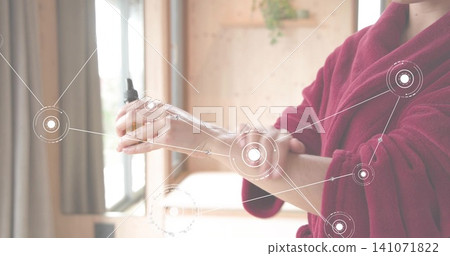 Dispensing woman in deep-red robe using amber bottle on arm at window, tech overlay, copy space Dispensing woman in deep-red robe using amber bottle on arm at window, tech overlay, copy space 141071822