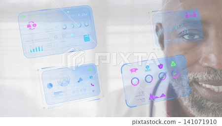 Smiling senior man, gray beard, collared shirt studying holographic UI panels at window, copy space 141071910