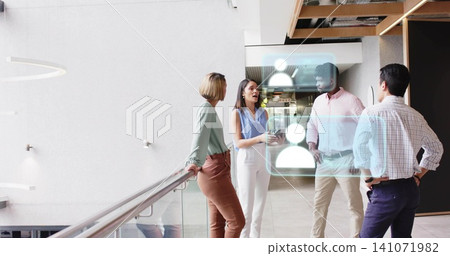 Holding tablet, woman in light blue blouse presenting to colleagues by glass railing, AR overlay Holding tablet, woman in light blue blouse presenting to colleagues by glass railing, AR overlay 141071982