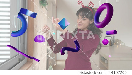 Arranging white lights, maroon sweater woman with reindeer headband near home window with 3D shapes Arranging white lights, maroon sweater woman with reindeer headband near home window with 3D shapes 141072001