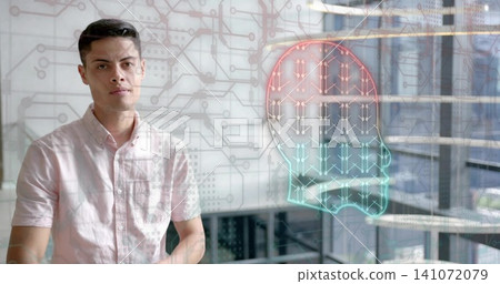 Standing man in light pink shirt facing glass in office, with neon brain circuitry, copy space Standing man in light pink shirt facing glass in office, with neon brain circuitry, copy space 141072079