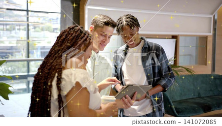 Examining tablet, three coworkers leaning in modern lounge, holding cup and wearing casual clothes Examining tablet, three coworkers leaning in modern lounge, holding cup and wearing casual clothes 141072085