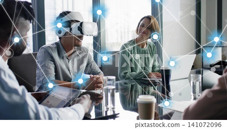 Testing business pro wearing white VR headset with hands on glass table, laptop, digital overlay Testing business pro wearing white VR headset with hands on glass table, laptop, digital overlay 141072096