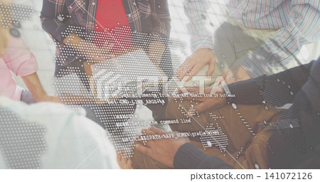 Joining team stacking hands at wooden table in office, plaid shirt, papers and digital overlay Joining team stacking hands at wooden table in office, plaid shirt, papers and digital overlay 141072126