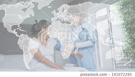 Checking patient in white hospital gown in exam room, clinician in light blue scrubs applying cuff 141072293