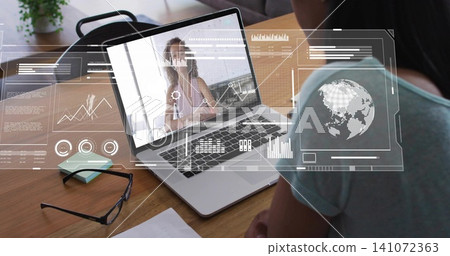Watching seated woman in teal top engaging presenter at home, laptop overlays, glasses, copy space Watching seated woman in teal top engaging presenter at home, laptop overlays, glasses, copy space 141072363