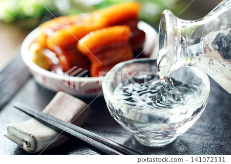 Sake is poured and braised pork belly is served. Sake is poured and braised pork belly is served. 141072531