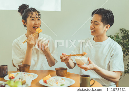 A couple smiling and talking to each other during a meal. A couple smiling and talking to each other during a meal. 141072581