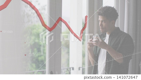 Holding mug, man wearing dark shirt gazing out glass doors at home, graph overlay, copy space Holding mug, man wearing dark shirt gazing out glass doors at home, graph overlay, copy space 141072647