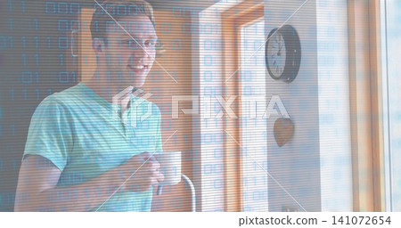 Smiling man wearing green striped shirt, holding white mug at home near window with binary overlay Smiling man wearing green striped shirt, holding white mug at home near window with binary overlay 141072654