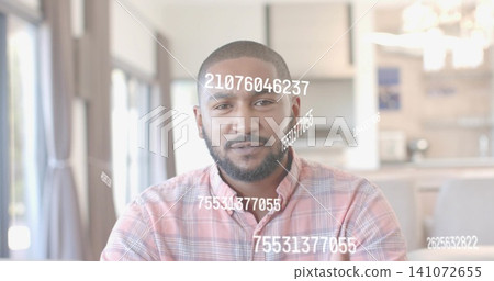 Sitting man wearing pink plaid shirt in bright living kitchen area, showing white numeric overlays Sitting man wearing pink plaid shirt in bright living kitchen area, showing white numeric overlays 141072655