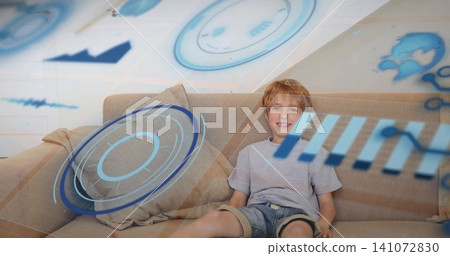 Smiling child leaning on beige sofa cushions at home, gray tee, denim shorts, HUD, copy space Smiling child leaning on beige sofa cushions at home, gray tee, denim shorts, HUD, copy space 141072830
