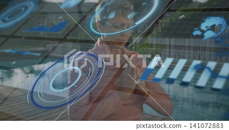 Manipulating mature woman wearing pink shirt adjusting AR holographic UI at atrium, with charts Manipulating mature woman wearing pink shirt adjusting AR holographic UI at atrium, with charts 141072883