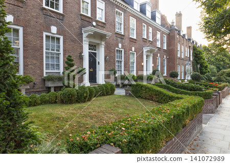Classic brick townhouses with manicured front gardens Classic brick townhouses with manicured front gardens 141072989