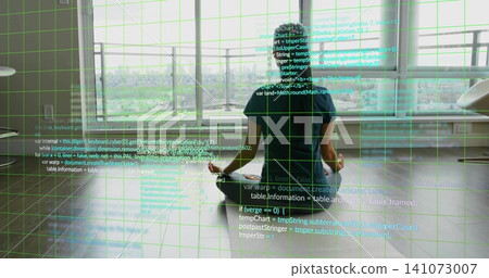 Sitting Asian woman wearing dark tee, meditating on floor in studio facing city, code grid overlay 141073007
