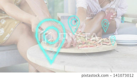 Reaching women sharing pizza on patio sofa, wood table, yellow dress, button top, turquoise pins Reaching women sharing pizza on patio sofa, wood table, yellow dress, button top, turquoise pins 141073012