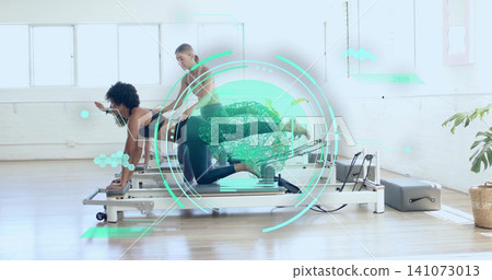 Kneeling woman in dark leggings working core on reformer in Pilates studio, trainer adjusting, HUD Kneeling woman in dark leggings working core on reformer in Pilates studio, trainer adjusting, HUD 141073013