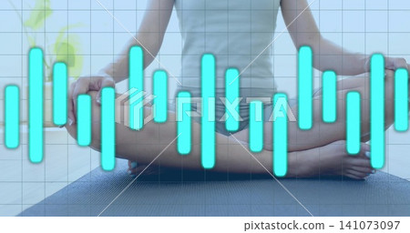 Sitting woman meditating at home in tank and shorts barefoot on yoga mat, with turquoise equalizer Sitting woman meditating at home in tank and shorts barefoot on yoga mat, with turquoise equalizer 141073097