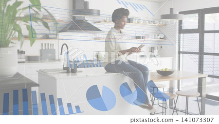 Checking phone, woman in white blouse and jeans sitting on kitchen island with floating data charts Checking phone, woman in white blouse and jeans sitting on kitchen island with floating data charts 141073307