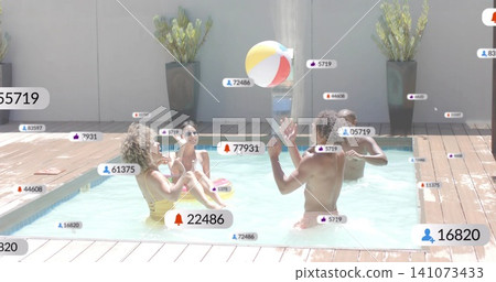 Playing four adults in swimsuits reaching for bright beach ball in private pool, with social icons Playing four adults in swimsuits reaching for bright beach ball in private pool, with social icons 141073433