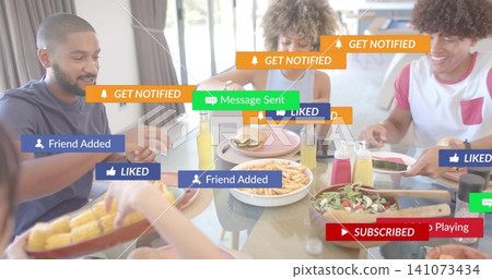 Sharing four friends in casual shirts passing plates at glass-top table, with food, phone, overlays Sharing four friends in casual shirts passing plates at glass-top table, with food, phone, overlays 141073434