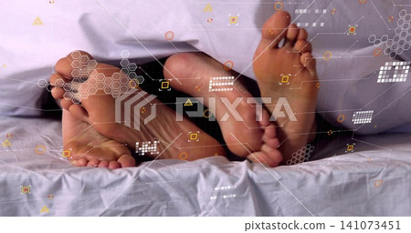 Showing two adult bare feet sticking out from under white sheet on bed, with HUD overlay Showing two adult bare feet sticking out from under white sheet on bed, with HUD overlay 141073451