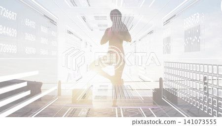 Balancing woman in tree pose wearing athletic top, leggings in studio with HUD and mat outlines 141073555