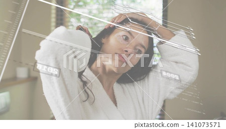 Pulling hair back, mid-adult woman wearing white bathrobe in bathroom, mirror showing markings Pulling hair back, mid-adult woman wearing white bathrobe in bathroom, mirror showing markings 141073571