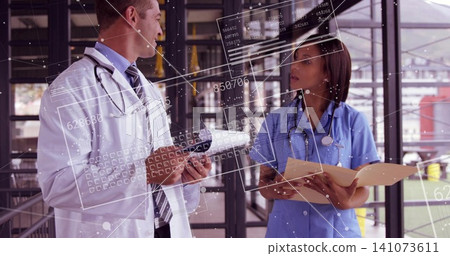 White coat doctor and nurse in light-blue scrubs reviewing manila file in glass atrium HUD overlays White coat doctor and nurse in light-blue scrubs reviewing manila file in glass atrium HUD overlays 141073611