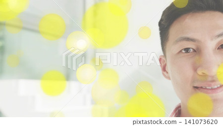 Showing Asian man wearing red-check shirt, showing right face in interior, yellow bokeh, copy space Showing Asian man wearing red-check shirt, showing right face in interior, yellow bokeh, copy space 141073620