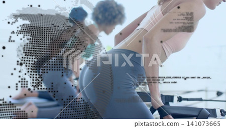 Leaning woman exercising on reformer in studio wearing tank and gray leggings, dotted code overlay Leaning woman exercising on reformer in studio wearing tank and gray leggings, dotted code overlay 141073665