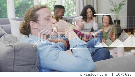 Lounging man wearing light blue shirt resting chin gazing in living room sofa, with data overlay Lounging man wearing light blue shirt resting chin gazing in living room sofa, with data overlay 141073685