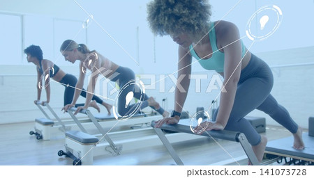 Doing pilates woman, teal tank and gray leggings pressing reformer footbar at studio, overlay nodes Doing pilates woman, teal tank and gray leggings pressing reformer footbar at studio, overlay nodes 141073728