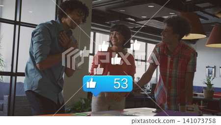 Laughing coworkers in red sweater, blue and plaid shirts at open office table, papers, thumbs-up 53 Laughing coworkers in red sweater, blue and plaid shirts at open office table, papers, thumbs-up 53 141073758