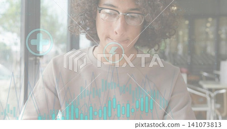 Analyzing man with clear eyeglasses light crewneck sweater reading at cafe window with candlesticks Analyzing man with clear eyeglasses light crewneck sweater reading at cafe window with candlesticks 141073813