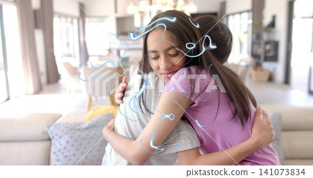 Embracing two females in living room, wearing pink and gray-striped tops, sofa, blue doodle overlay Embracing two females in living room, wearing pink and gray-striped tops, sofa, blue doodle overlay 141073834