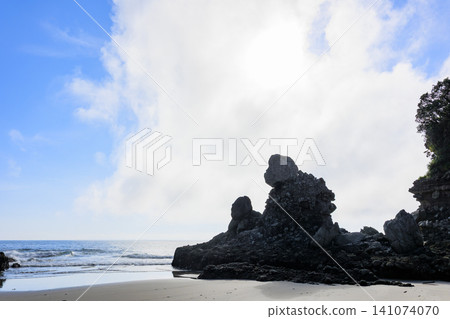 The bizarre rock formation of Ningyo-iwa stands against the blue sky and the East China Sea. Nishikata, Satsumasendai City, Kagoshima Prefecture. The bizarre rock formation of Ningyo-iwa stands against the blue sky and the East China Sea. Nishikata, Satsumasendai City, Kagoshima Prefecture. 141074070