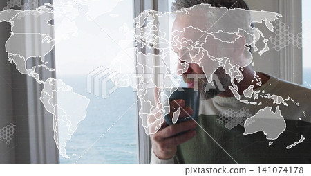Holding dark mug, man sipping by ocean window, wearing earbud, sweater, map overlay, copy space Holding dark mug, man sipping by ocean window, wearing earbud, sweater, map overlay, copy space 141074178