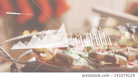 Displaying decorated cookies on metal tray at cozy kitchen table, with data overlay and red sweater Displaying decorated cookies on metal tray at cozy kitchen table, with data overlay and red sweater 141074229