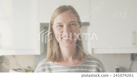 Posing woman in gray striped top smiling at camera in kitchen with toaster, plant, formula overlay Posing woman in gray striped top smiling at camera in kitchen with toaster, plant, formula overlay 141074261