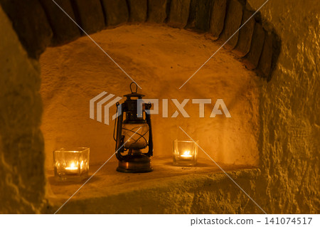 Warm light illuminating alcove with vintage lantern and candles Warm light illuminating alcove with vintage lantern and candles 141074517
