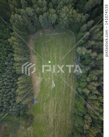 Forest clearing aerial view showing camping activity in Czechia Forest clearing aerial view showing camping activity in Czechia 141074538