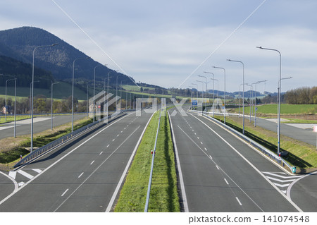 Empty wide highway with multi lane asphalt road Empty wide highway with multi lane asphalt road 141074548