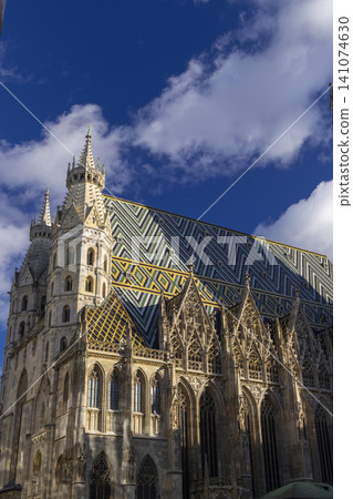 St. Stephen's Cathedral in Vienna showing colorful tiled roof and gothic architecture 141074630